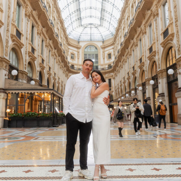 Destination engagement photoshoot of a couple in Milan at Galleria Vittorio Emanuele II, captured by destination wedding photographer Paulina Hindy.